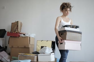 concentrated-woman-carrying-stack-of-cardboard-boxes-for-3791617